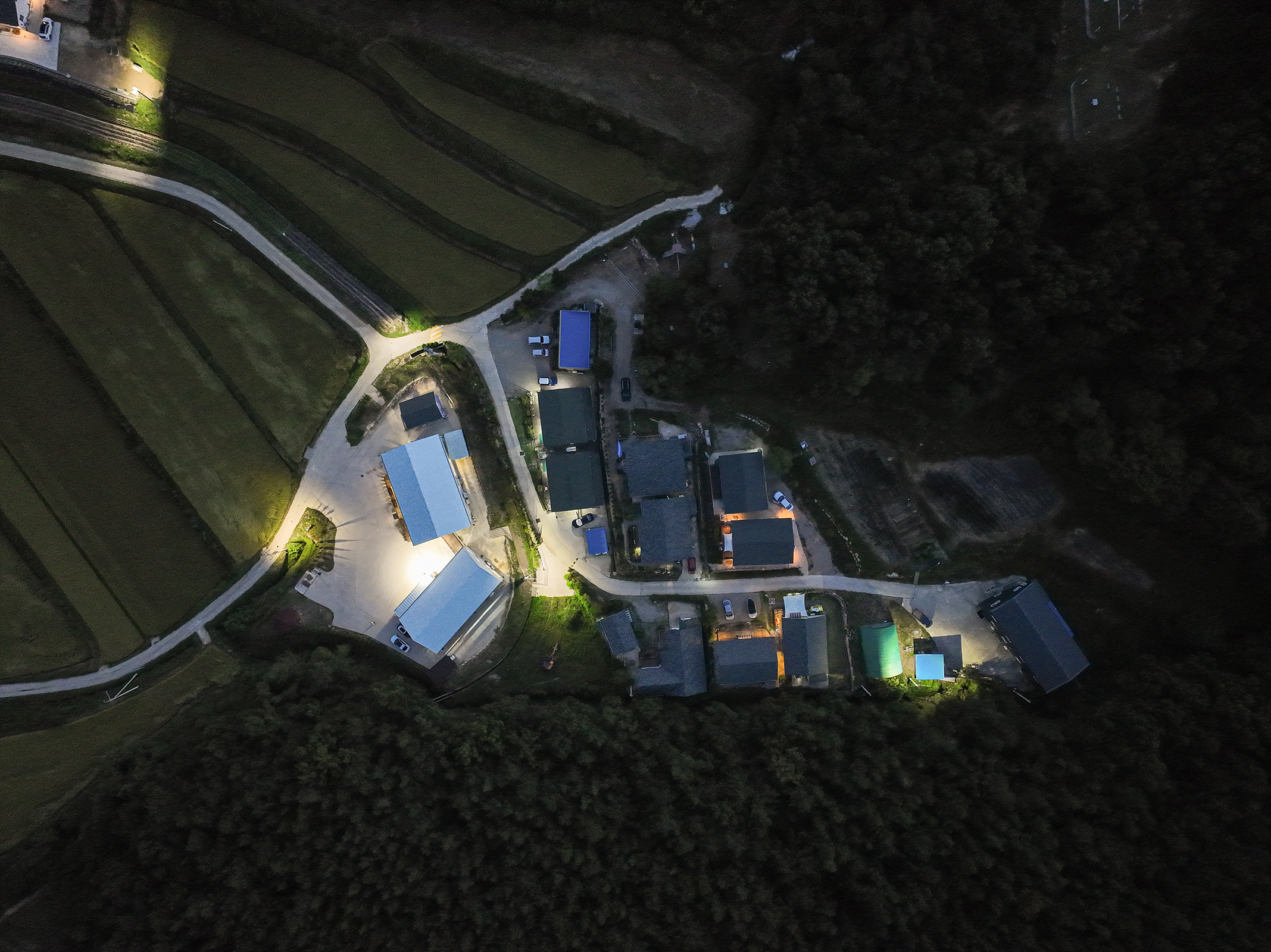 A concrete single-story house designed by BYHAND at dusk